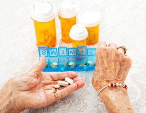 elderly person organizing pills medfolio cares