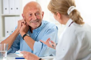 doctor talking to elderly patient medfolio cares