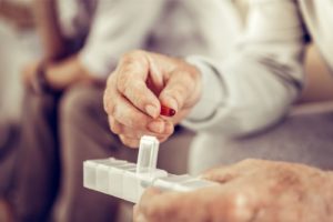 elderly person taking pills medfolio cares