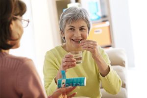 elderly woman taking pills medfolio cares