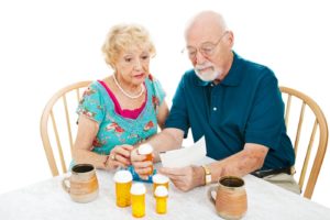 elderly people looking at pills medfolio cares